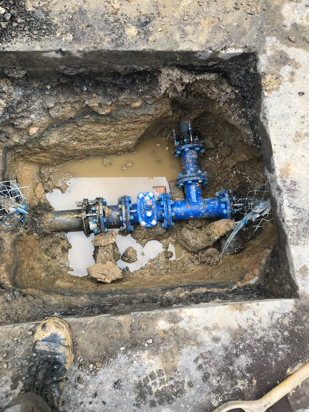 Main fittings installed in excavated trench