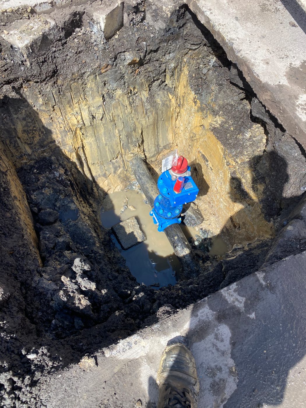 Road valve and main exposed in carriageway